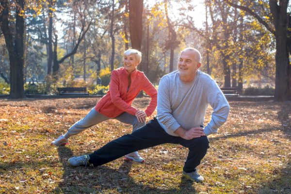 closeup-smiling-caucasian-senior-couple-exercising-park-sunny-autumn-day