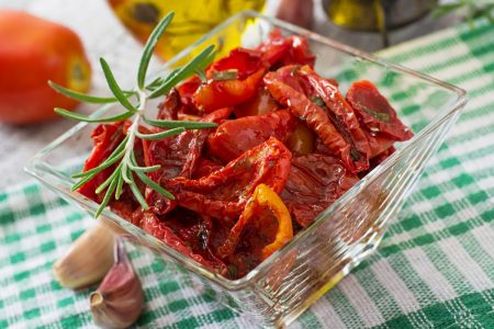 sun-dried-tomatoes-with-herbs-garlic-wooden-bowl